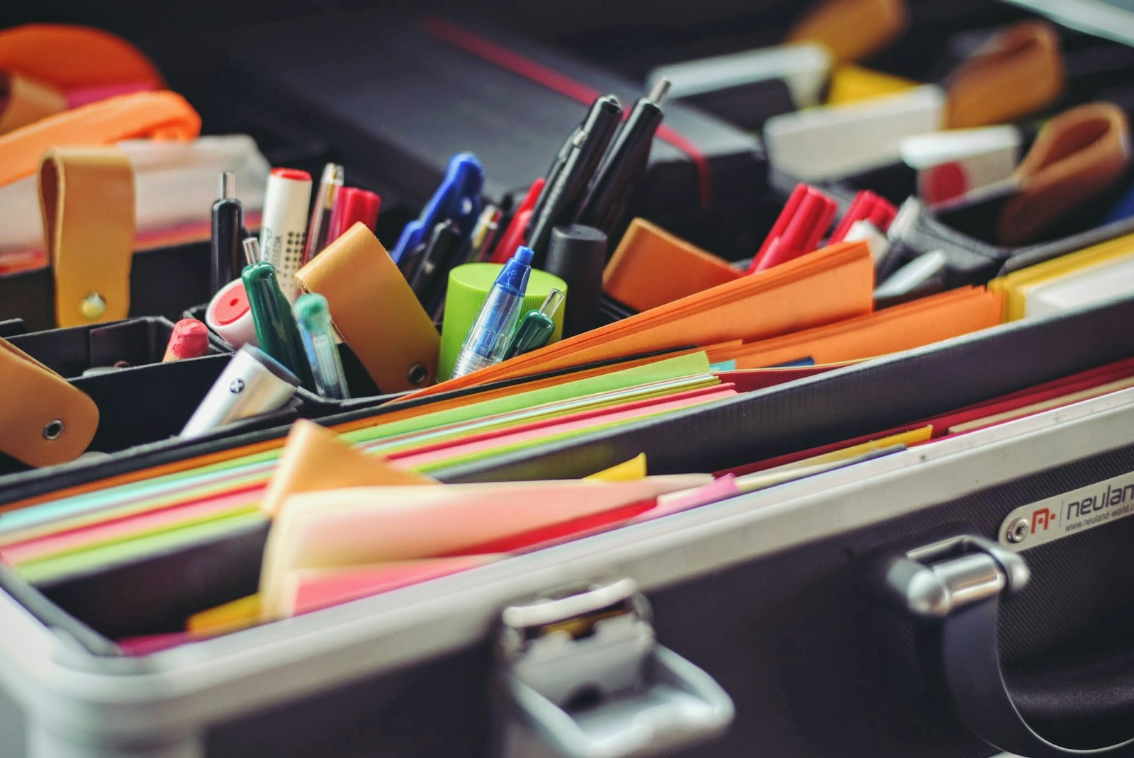 Desk with paper, notes, and everyday office supplies